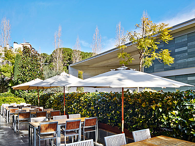 Outdoor-Terrasse der Expanish Sprachschule Barcelona mit schattigen Sitzbereichen für Schüler während der Spanisch Sprachreise.