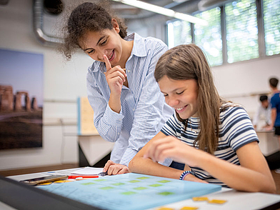 Zwei Jugendliche beim spielerischen Deutschlernen im Klassenraum der FU Heidelberg im Junior Deutschkurs